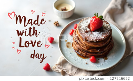 Romantic stack of pancakes with a strawberry and powdered sugar made with love 127216632