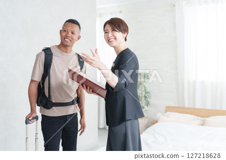 Asian hotel staff and foreign tourists Asian hotel staff and foreign tourists 127218628