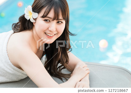 A woman receiving a massage at a tropical spa, beauty salon, or esthetic salon A woman receiving a massage at a tropical spa, beauty salon, or esthetic salon 127218667