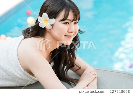 A woman receiving a massage at a tropical spa, beauty salon, or esthetic salon A woman receiving a massage at a tropical spa, beauty salon, or esthetic salon 127218668