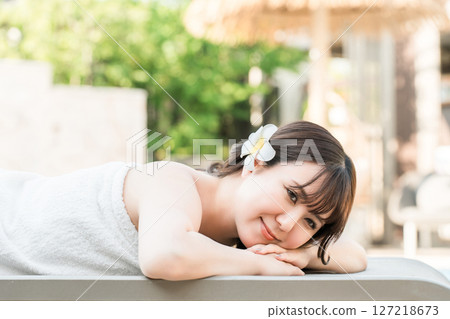 A woman receiving a massage at a tropical spa, beauty salon, or esthetic salon A woman receiving a massage at a tropical spa, beauty salon, or esthetic salon 127218673
