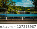 View of suburban mountains and towns beyond the guardrail 127218987