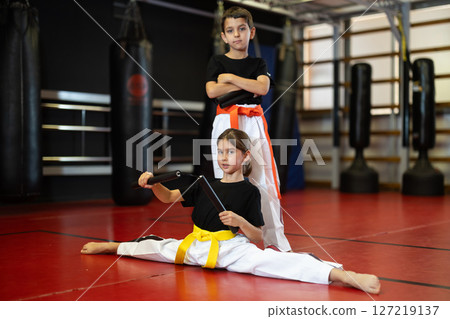 Children holding nunchucks in their hands Children holding nunchucks in their hands 127219137