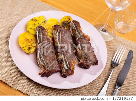 Steak served with potatoes on platter 127219187