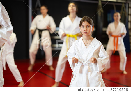Teenage girl in kimono at karate lesson 127219228