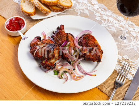 Traditional european dish Shashlik cordero - fried lamb kebab with onion on plate Traditional european dish Shashlik cordero - fried lamb kebab with onion on plate 127219232
