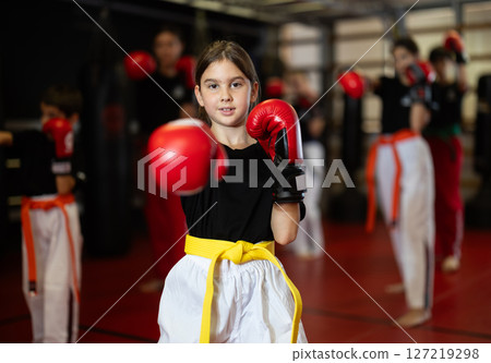 Girl in red boxing gloves on renovation Girl in red boxing gloves on renovation 127219298