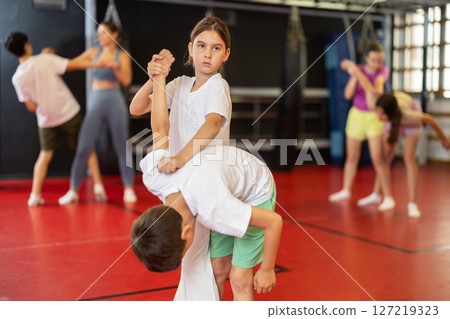 Boy and girl practice self-defense in pairs 127219323