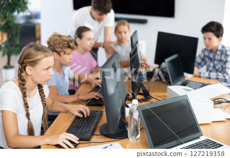 Girl student learning to work on computer in classroom 127219358
