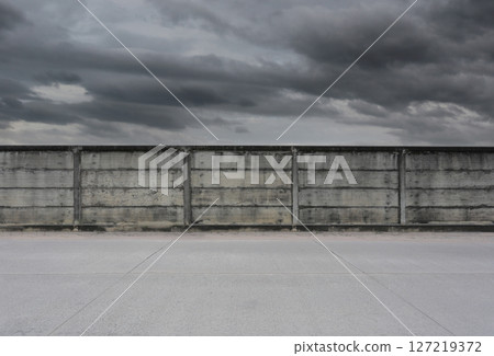 Concrete wall and the rain clouds are coming sky background. 127219372