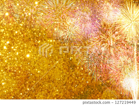 Colorful fireworks bursting in the night sky with a shimmering golden background, creating a vibrant and festive atmosphere for celebrations and events 127219449