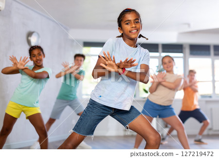 African boy perform choreographic exercises and teach energetic social dance waacking with friends 127219472