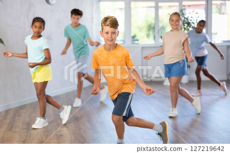 Dance studio - smiling girls and boys in dance lesson Dance studio - smiling girls and boys in dance lesson 127219642