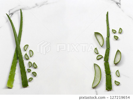 Fresh Aloe Vera Leaves Arranged on Marble Surface with Cut Sections Displaying Succulent Green Texture Ideal for Health and Wellness Themes in Stock Photography Fresh Aloe Vera Leaves Arranged on Marble Surface with Cut Sections Displaying Succulent Green Texture Ideal for Health and Wellness Themes in Stock Photography 127219654
