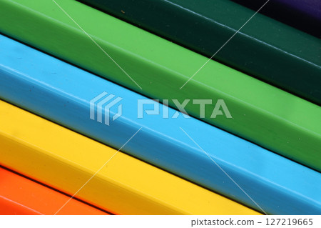 Vibrant Colorful Stacks of Plastic Strips Arranged in a Neat Pattern Showcasing Bright Hues of Green, Blue, Yellow, Red, Orange, and Purple for Creative Projects 127219665