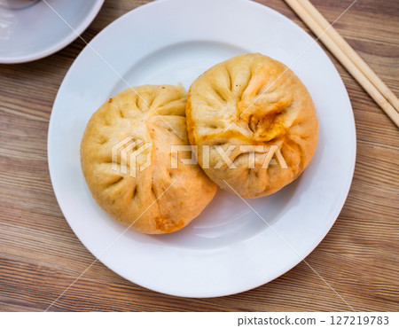 There is portion of pan chino buns with minced meat on plate - traditional Asian baozi 127219783