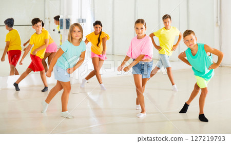 Children studying modern style dances in class indoors Children studying modern style dances in class indoors 127219793