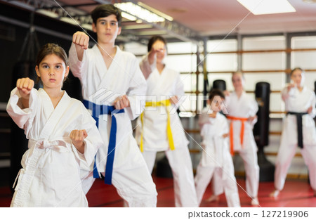 Children students repeat position and perform sequence of punches and painful techniques kata Children students repeat position and perform sequence of punches and painful techniques kata 127219906