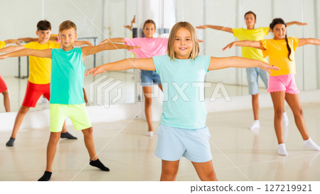 Young girls and boys performing dance in studio Young girls and boys performing dance in studio 127219921