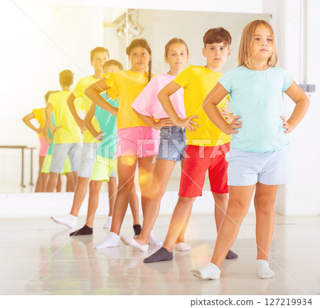 Children primary school age rehearsing movements of ballet dance in modern studio Children primary school age rehearsing movements of ballet dance in modern studio 127219934