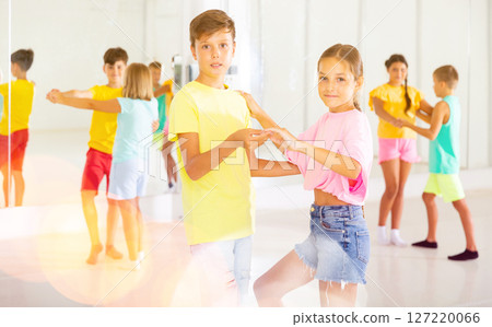 Portrait of children enjoying of partner dance in class 127220066