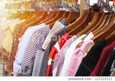 Colorful Dresses Hanging in a Retail Store Display 127220311
