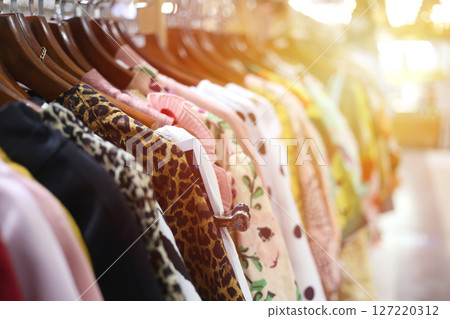 Colorful Dresses Hanging in a Retail Store Display 127220312