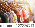 Colorful Dresses Hanging in a Retail Store Display 127220313