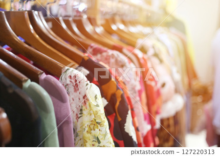 Colorful Dresses Hanging in a Retail Store Display 127220313