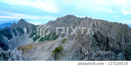 A panoramic view of the Hotaka mountain range in midsummer from the summit of Mt. Kitahotakadake in the quiet early morning A panoramic view of the Hotaka mountain range in midsummer from the summit of Mt. Kitahotakadake in the quiet early morning 127220510