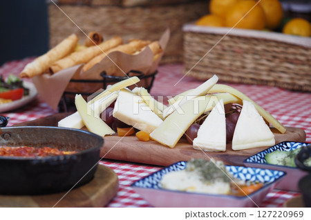 A beautifully arranged Artisanal Cheese Platter complete with accompanying items 127220969