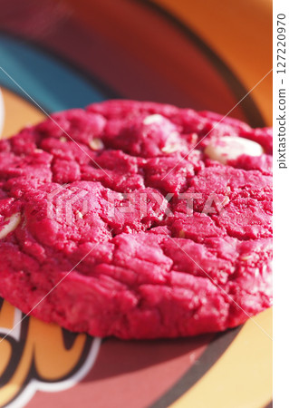 A Vibrant Red Cookie set against a Beautifully Colorful Background 127220970