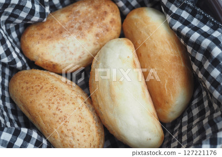 Freshly Baked Soft Bread Rolls Presented in a Charming Checkered Basket Freshly Baked Soft Bread Rolls Presented in a Charming Checkered Basket 127221176
