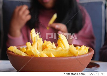 child eating french fries close up child eating french fries close up 127221190