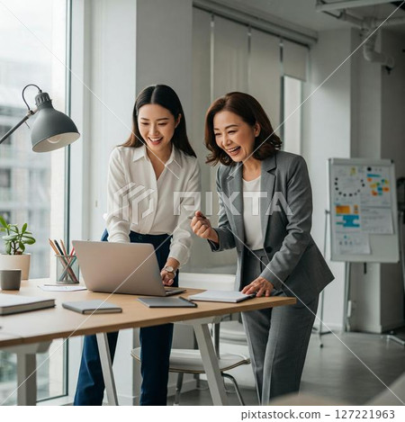 Smiling businesswoman working in the office 127221963