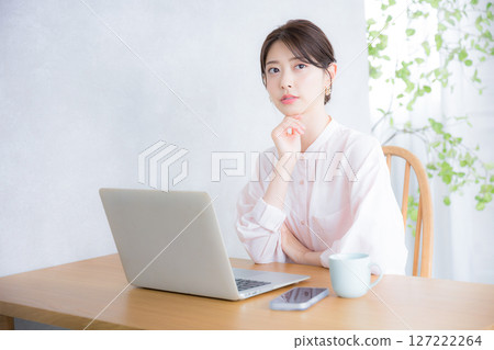 Thinking in front of a computer Office casual image Sheer shirt woman What should I do about changing jobs? Looking at the camera 127222264