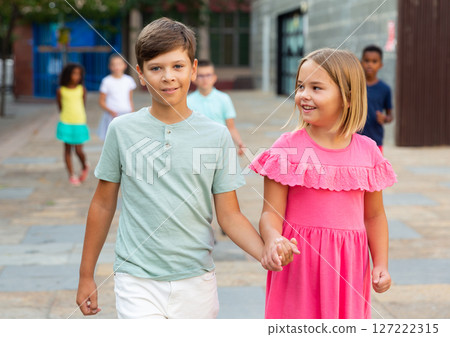 Boy and girl walking together hand in hand Boy and girl walking together hand in hand 127222315