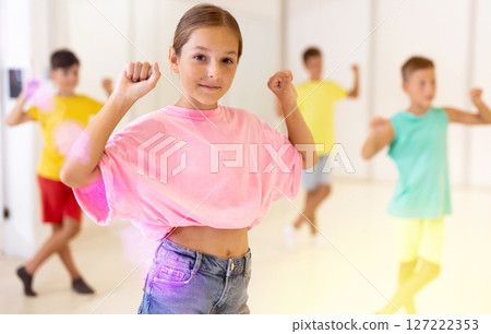 Positive children studying modern style dance in class Positive children studying modern style dance in class 127222353