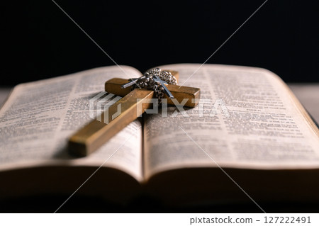 Religious belief concept Close up prayer Christian church service Bible Holy cross Spiritual power Blurred background Desk copy space Heaven God Catholic faith Praise book Jesus worship Gospel symbols 127222491
