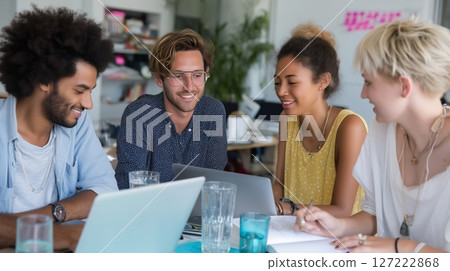 Group collaboration in a modern workspace during a brainstorming session 127222868