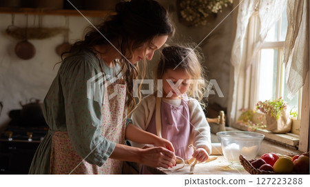Cooking together in a rustic kitchen with a mother and daughter sharing a joyful baking moment Cooking together in a rustic kitchen with a mother and daughter sharing a joyful baking moment 127223288
