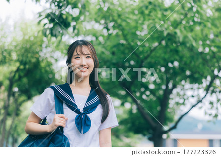 A high school girl in summer clothes commuting to school 127223326