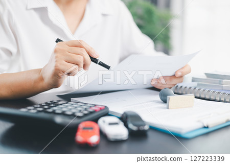 Businesswoman hand stamp approve on financial business approval document paper. Man hand accept permit contract agreement. Broker manager sign contract bank guarantee approved stamp application form 127223339