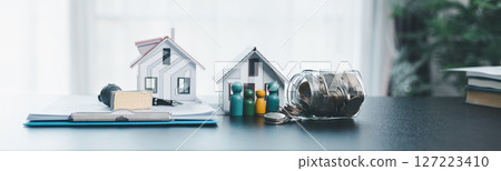 Banner of rubber stamp calculator, loan house model on table, home loan approved on loan application form document paper, approval business finance economy commercial real estate investments concept. Banner of rubber stamp calculator, loan house model on table, home loan approved on loan application form document paper, approval business finance economy commercial real estate investments concept. 127223410