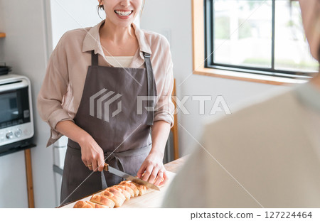 Back view of a female instructor and female student teaching cooking at a cooking class/cooking school Back view of a female instructor and female student teaching cooking at a cooking class/cooking school 127224464