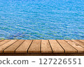 wooden table top with blue sea summer background. 127226551