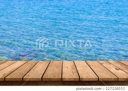 wooden table top with blue sea summer background. wooden table top with blue sea summer background. 127226551