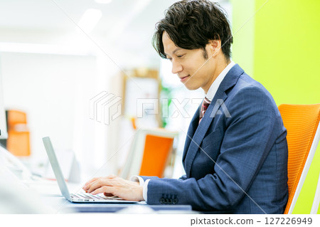 A young businessman working in the office A young businessman working in the office 127226949