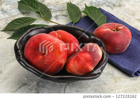 Ripe sweet and juicy Flat peach 127228162