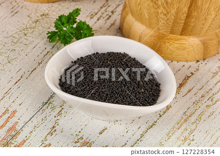 Black dry Nigella seeds in the bowl 127228354